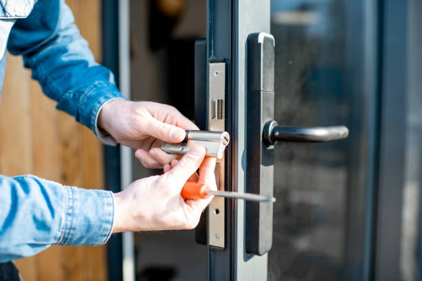 istockphoto-1138823660-612x612 Man changing core of a door lock of the entrance glass door, close-up view with no face